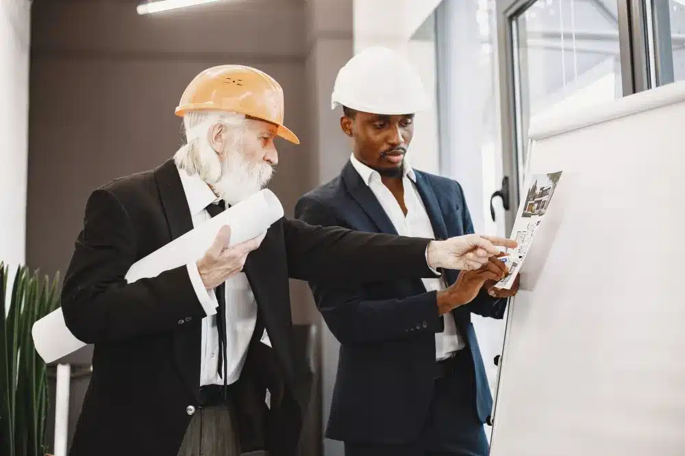 Contractor reviewing office build-out plans with client during a free in-home estimate consultation