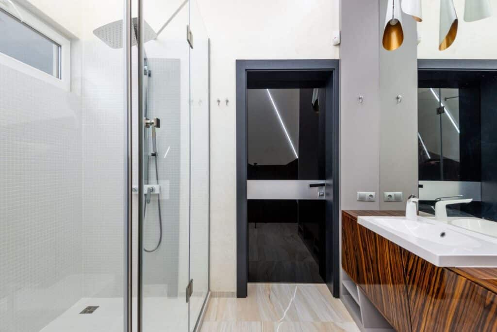 Frameless glass shower enclosure installed during shower remodeling in Arlington TX bathroom