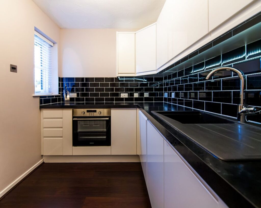 Modern small kitchen remodel with white cabinets and open shelving in Arlington TX home