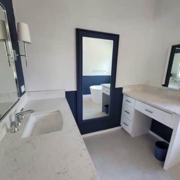 bathroom remodel with vanity and large mirror