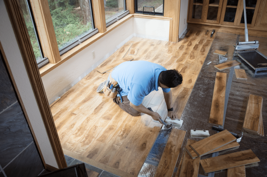 worker installing wood floor