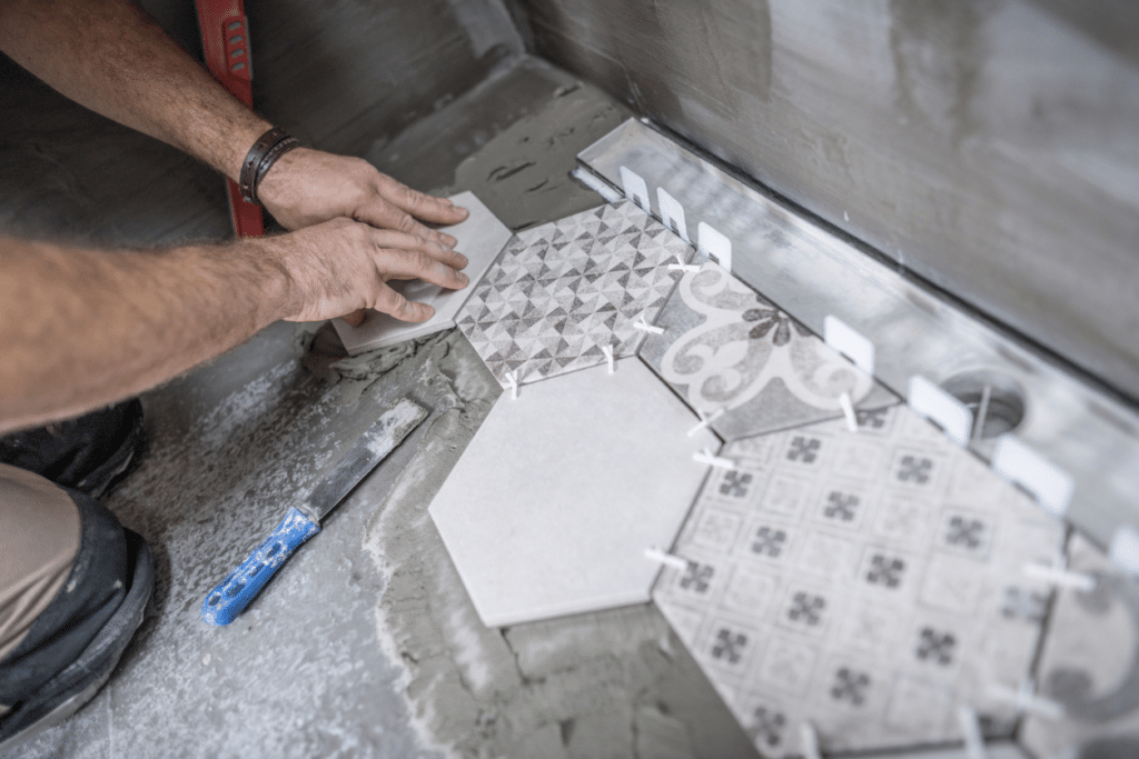 worker installing ceramic tile floor