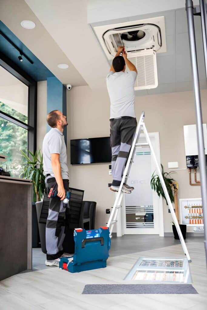 technician repairing outdoor air conditioner unit during maintenance service