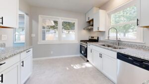 Bright modern kitchen remodel featuring warm wood cabinets and quartz countertops in Arlington TX