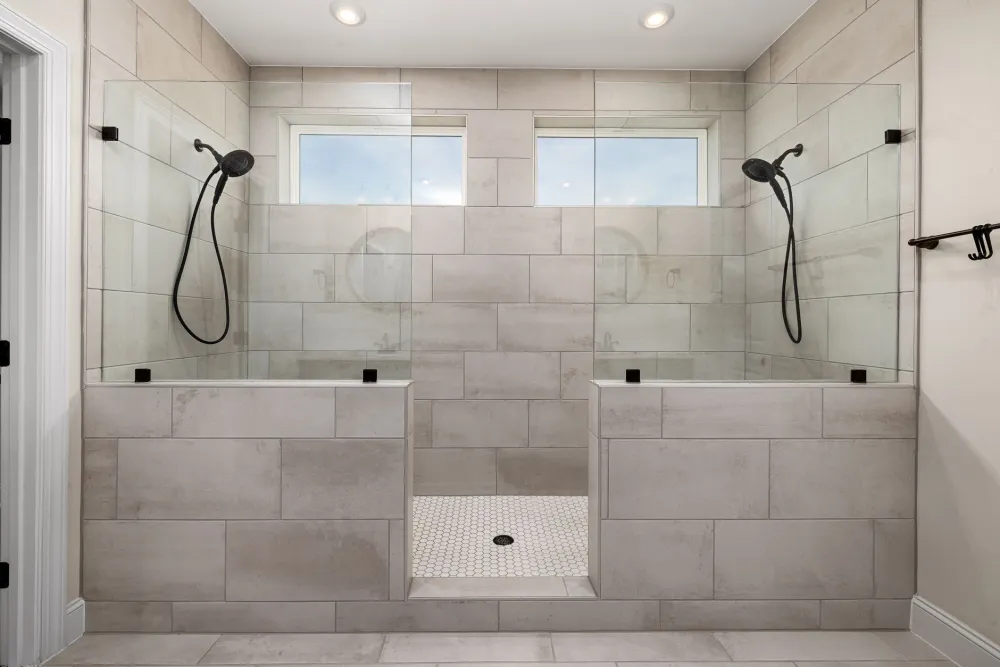 Walk-in shower with grab bars and non-slip tile floor for senior safety