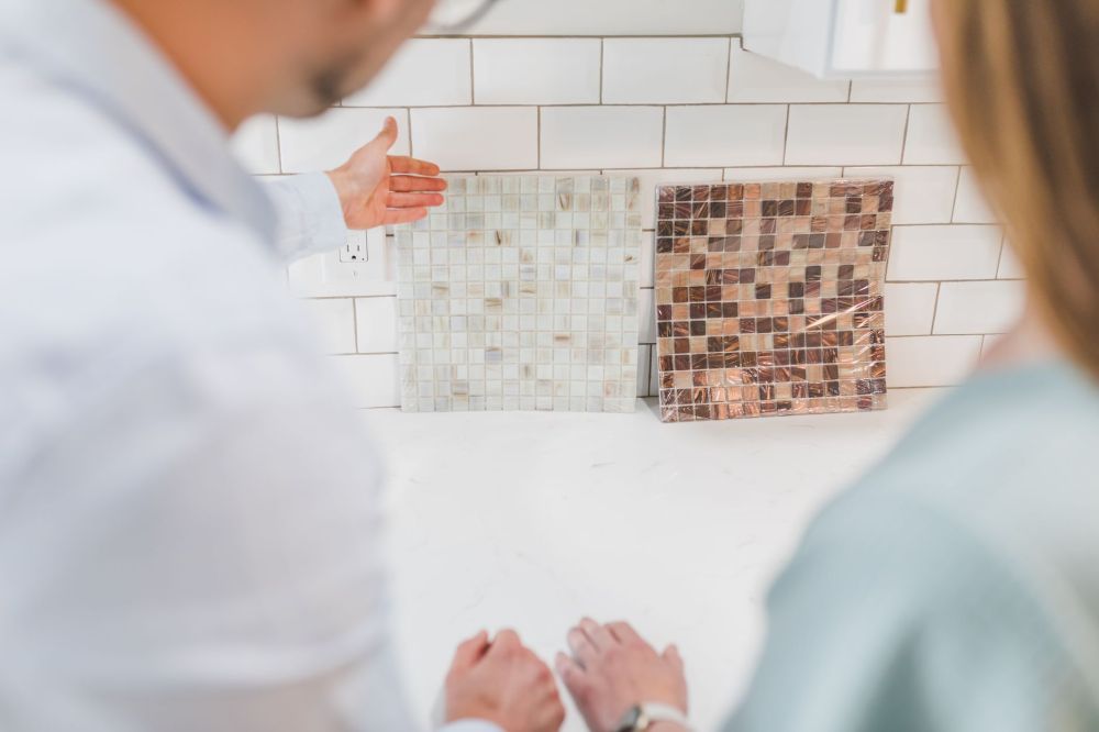 Interior designer reviewing kitchen remodeling plans with a homeowner at a table
