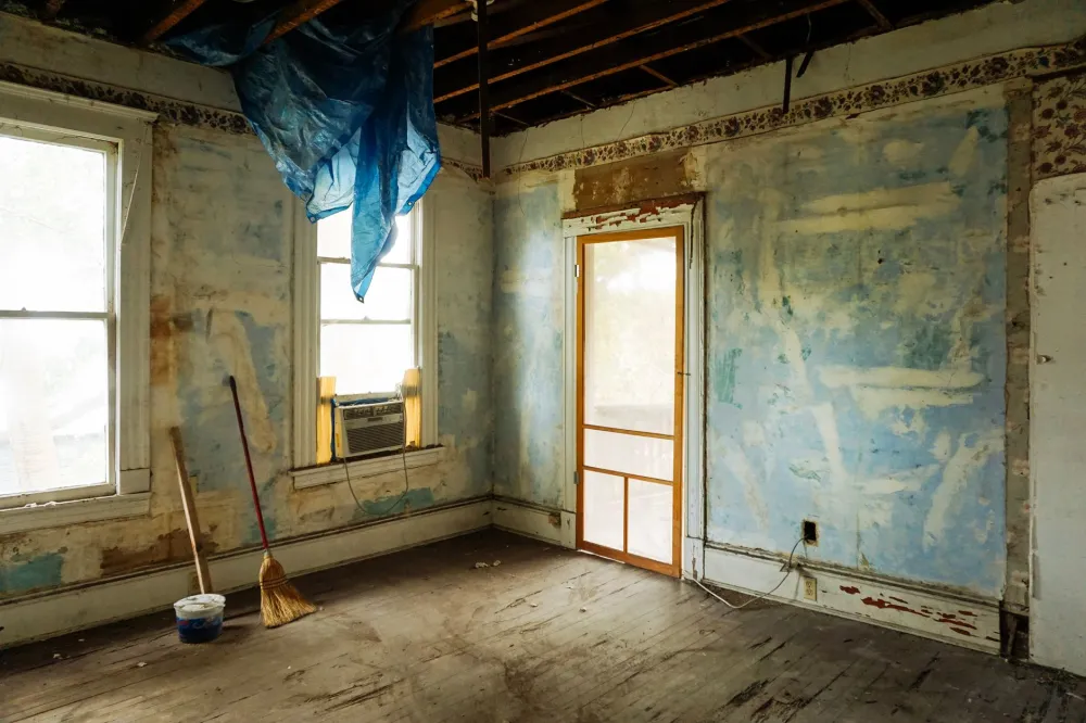 Contractor removing old tile during bathroom demolition phase of a remodel
