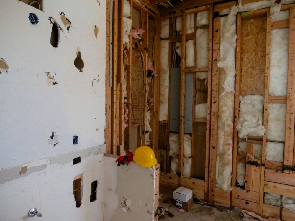 Contractor installing drywall framing during commercial retail space finish-out project