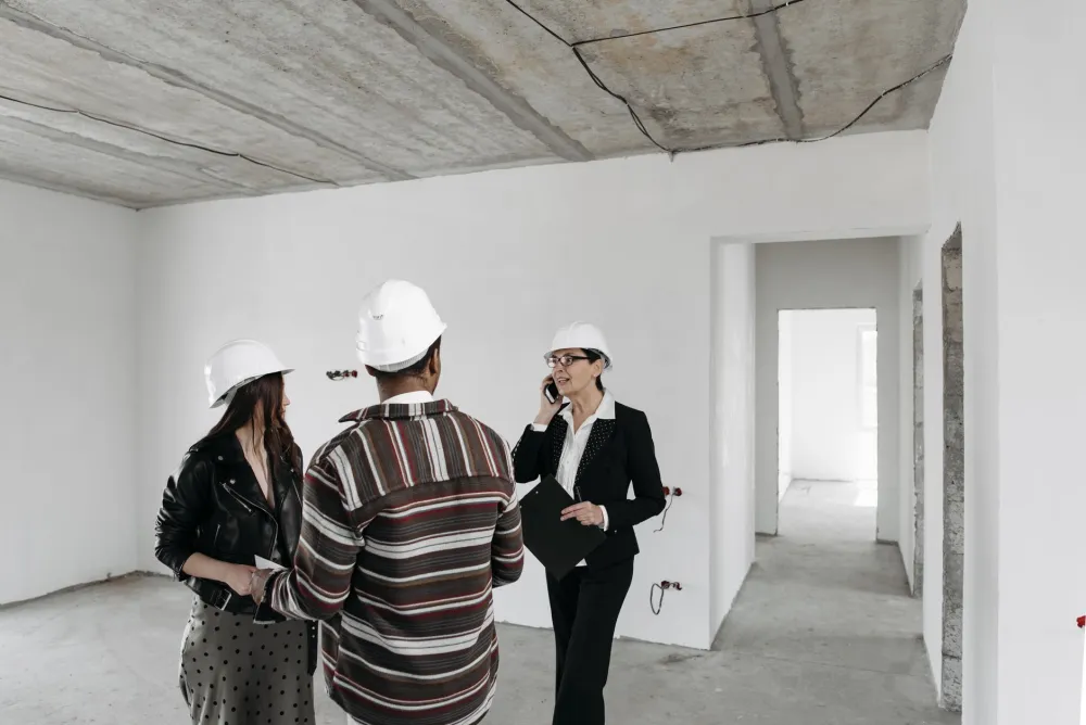 Homeowner and contractor reviewing whole-home improvement plans during in-home consultation