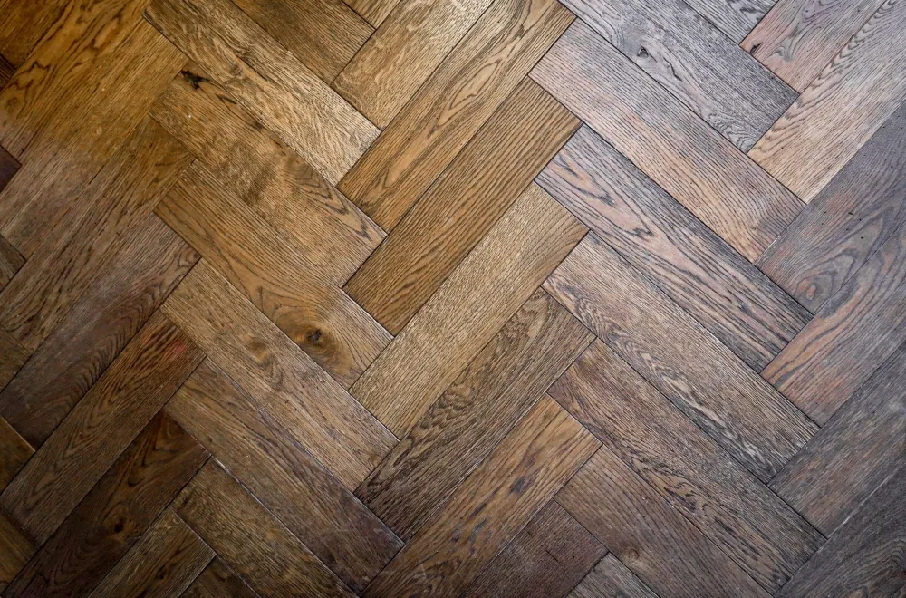 Installer laying luxury vinyl plank flooring during an Arlington TX home improvement project