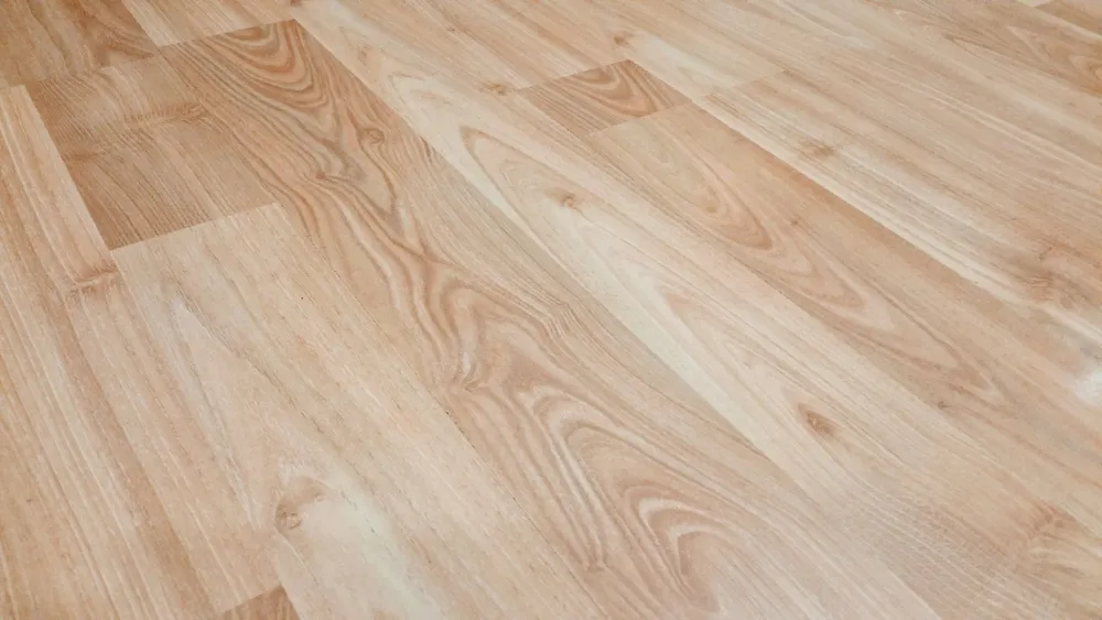 Contractor installing luxury vinyl plank flooring during Arlington TX home improvement project