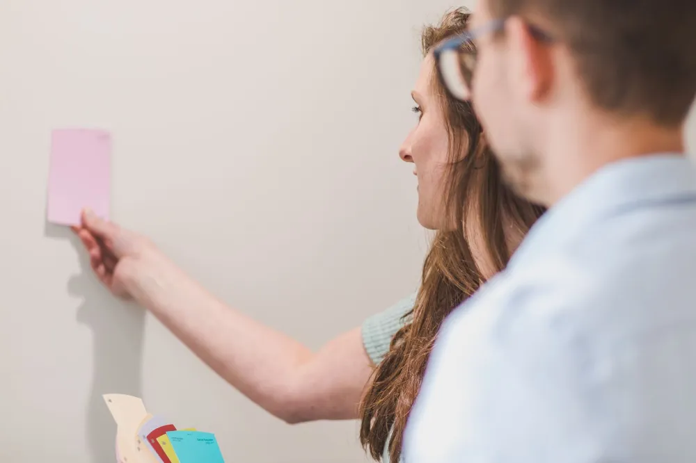 Homeowner selecting interior paint colors for a DFW home improvement refresh