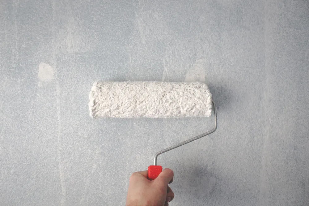 Professional painter applying fresh interior paint during Arlington Texas home improvement