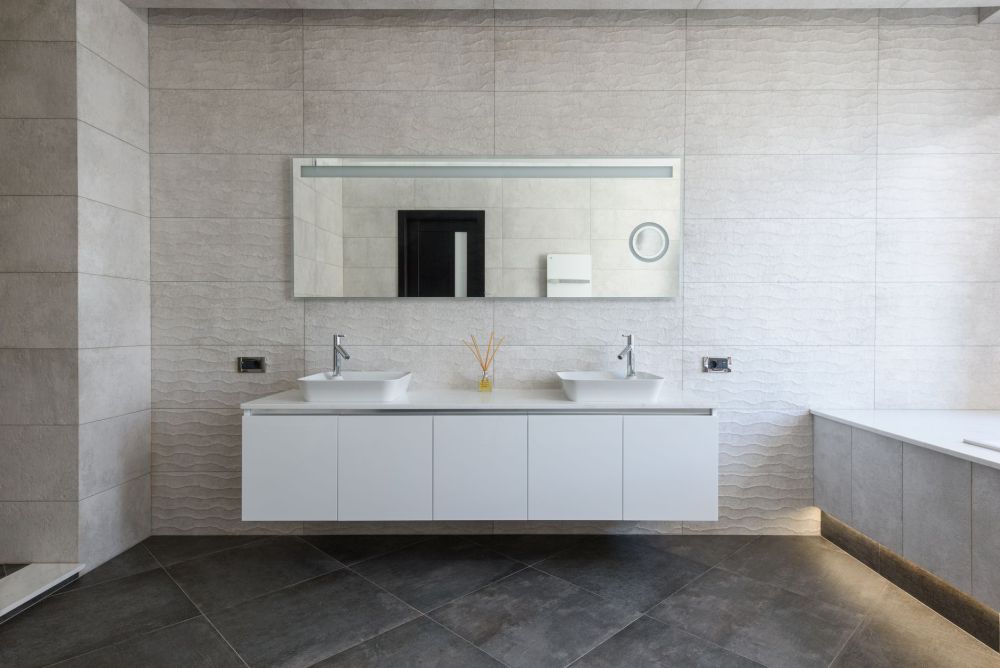 Double sink bathroom vanity with matte black fixtures in a renovated master bath