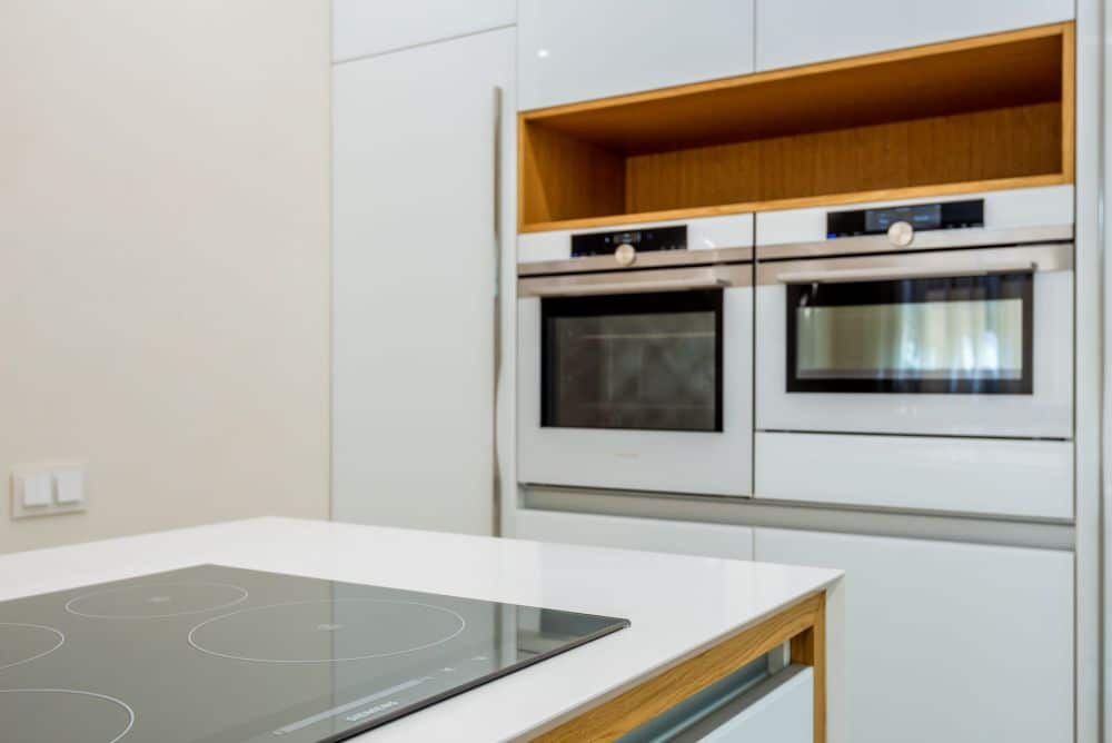 Sleek integrated appliances and induction cooktop in a modern kitchen renovation