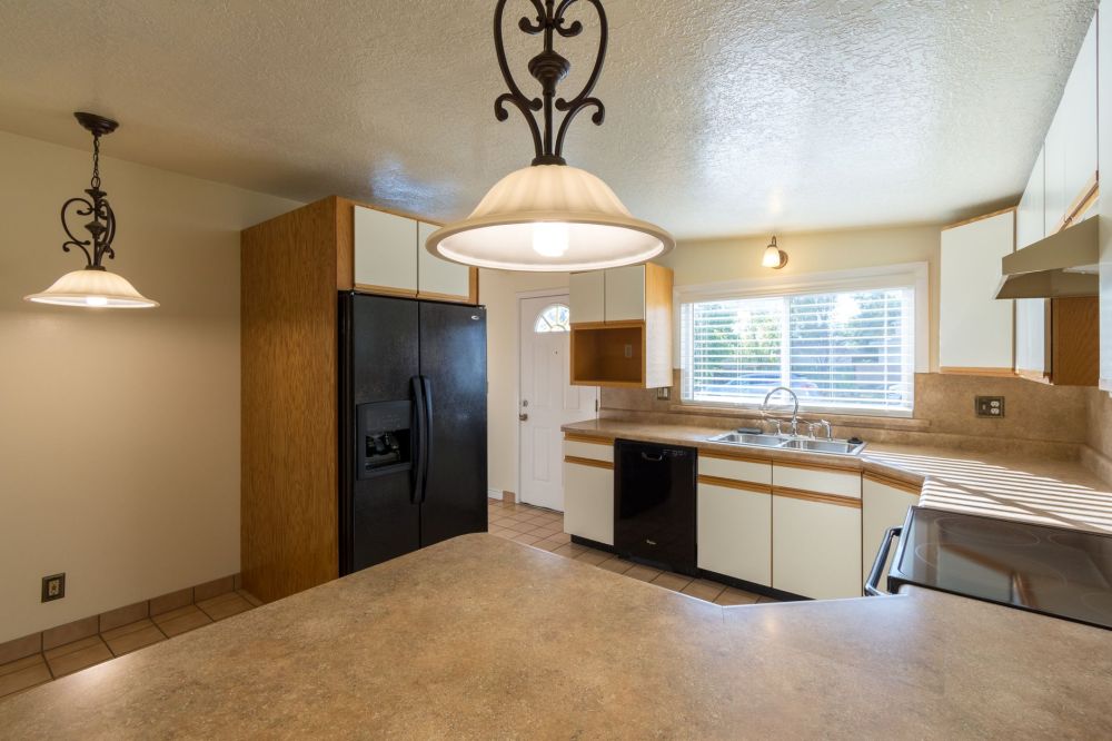 Outdated dark kitchen cabinets in a 1990s Texas ranch home before remodeling