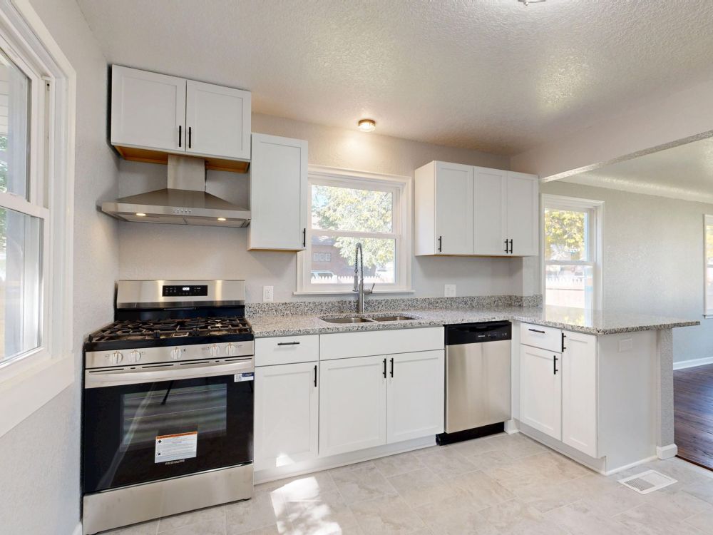 Freshly remodeled kitchen with warm wood cabinets and updated hardware in DFW home