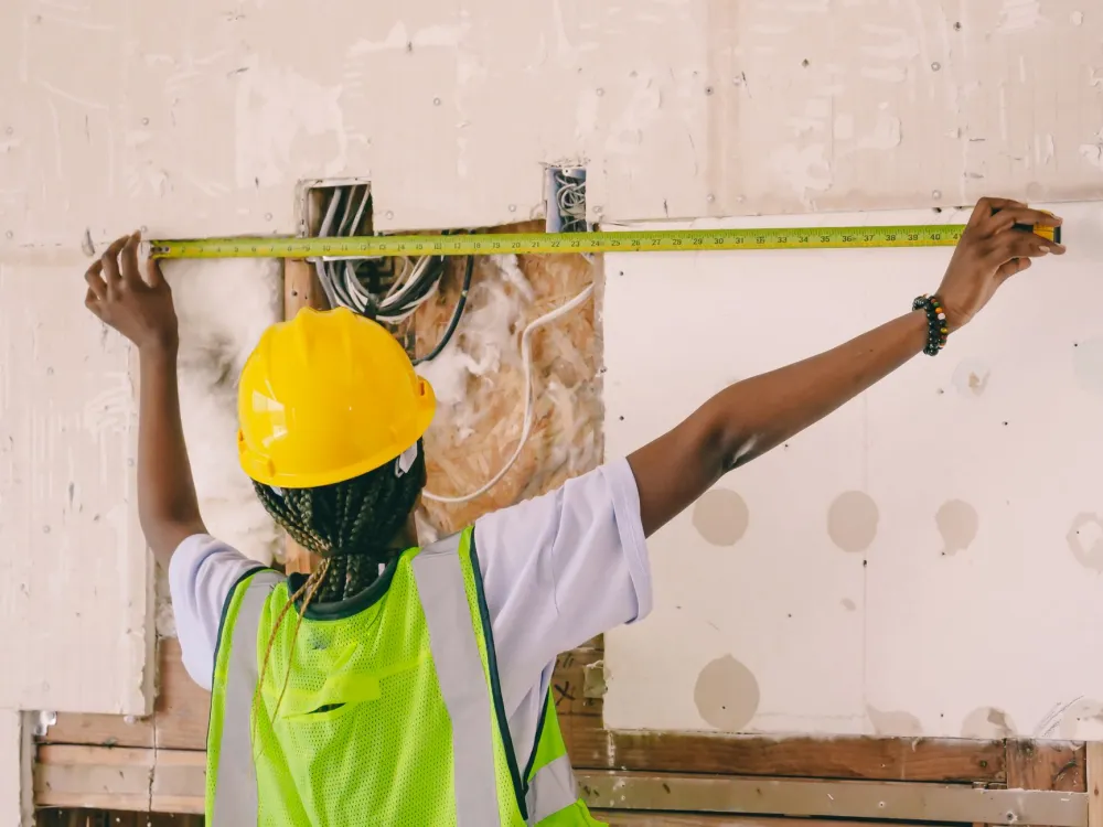 Remodeling contractor removing a load-bearing wall for an open-concept kitchen conversion
