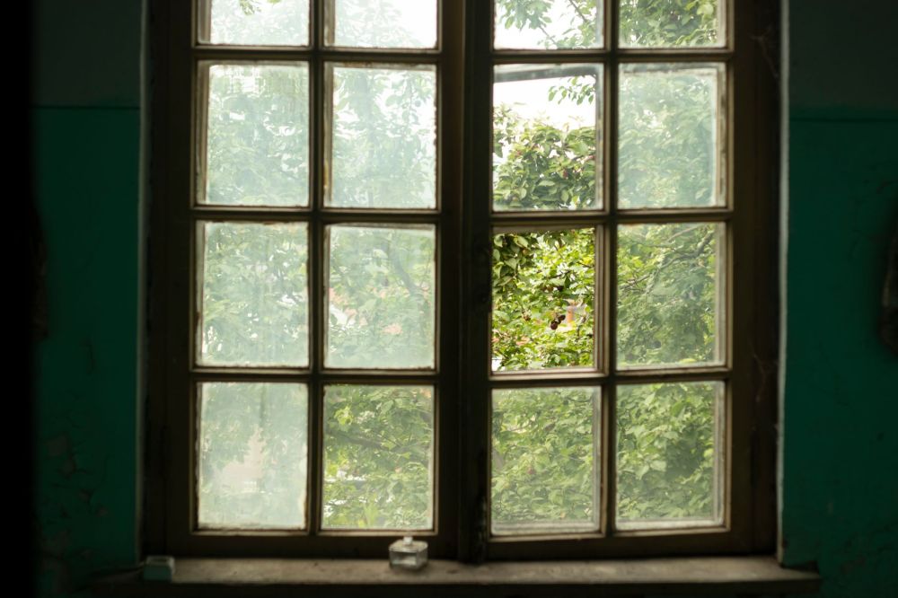 Old single-pane drafty window causing energy loss in a Texas home
