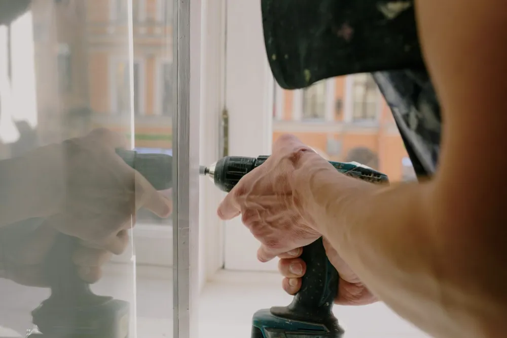 Contractor installing double-pane replacement windows in a Texas residential home