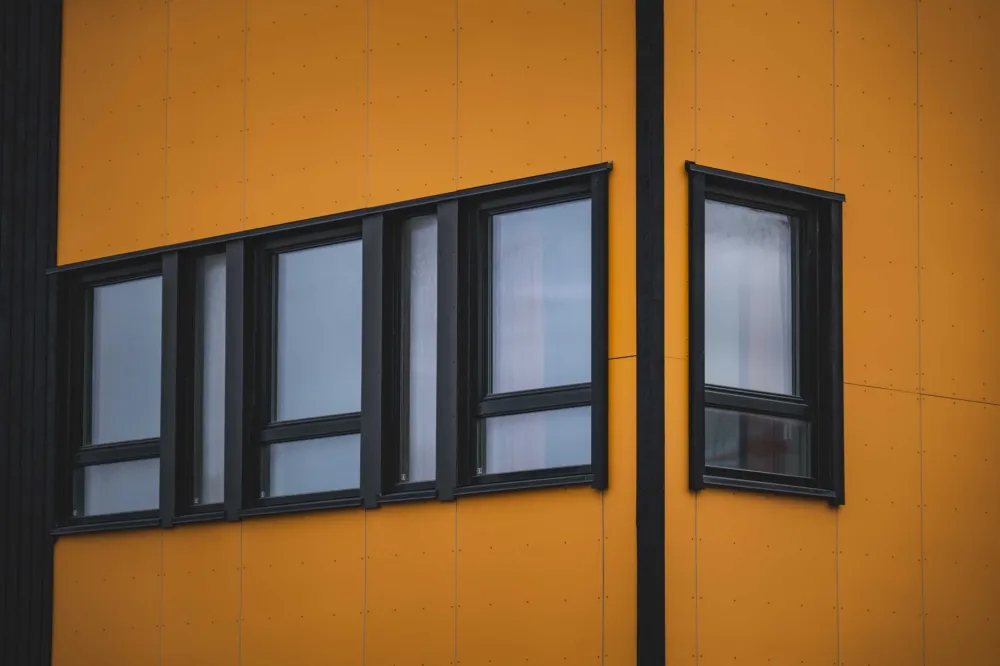 Vinyl and fiberglass window frames compared side by side for replacement windows