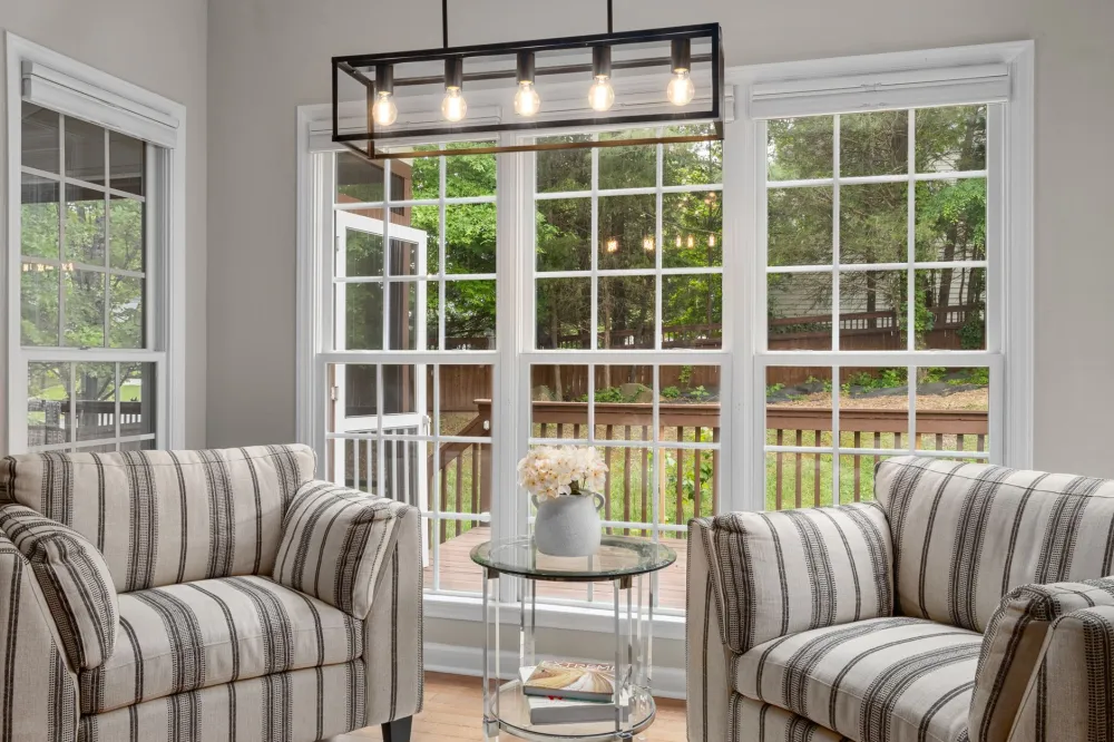 Bright living room with new energy-efficient replacement windows in a DFW home