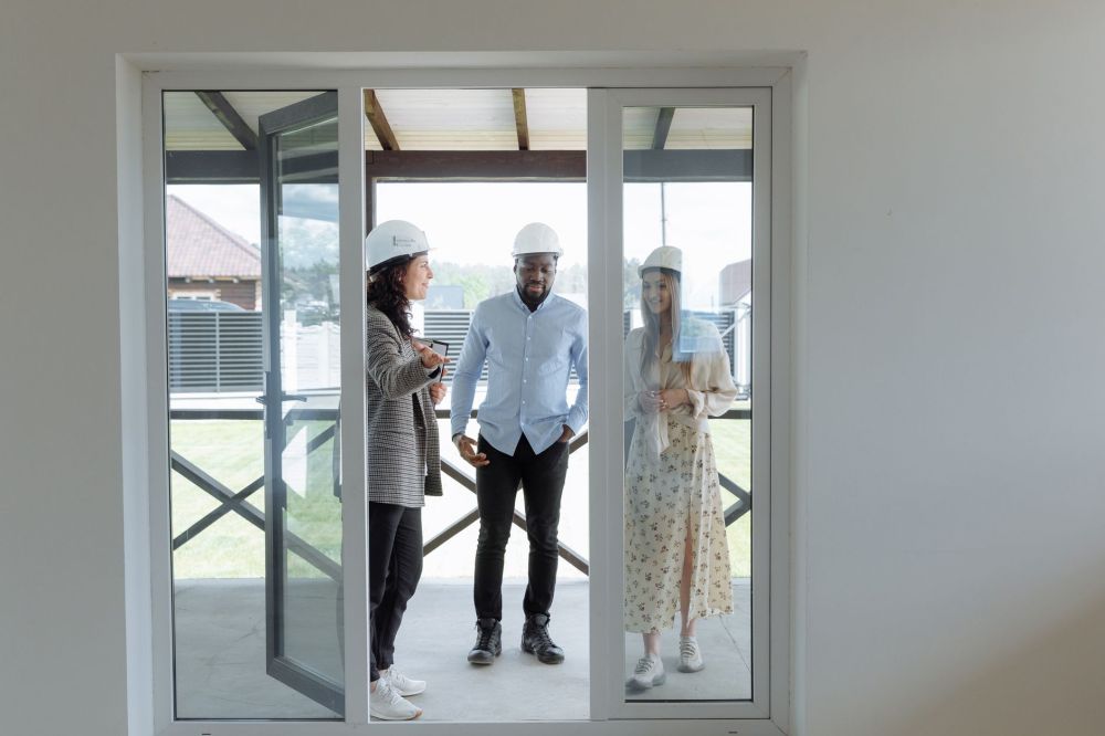 Remodeling contractor measuring windows during a free in-home estimate visit