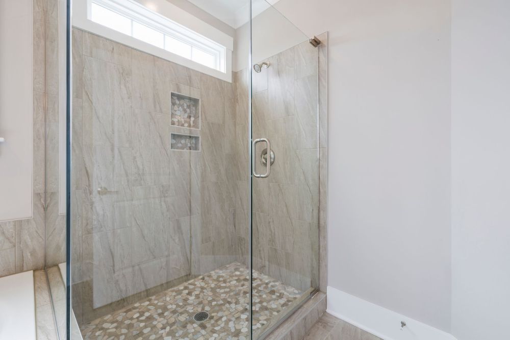 Completed shower remodel with frameless glass door and fresh tile in Hurst Texas
