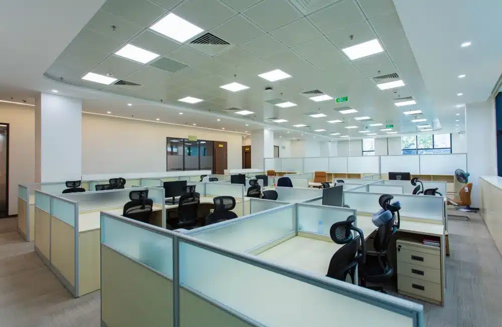 Finished commercial office ceiling with recessed lighting and HVAC vents in place