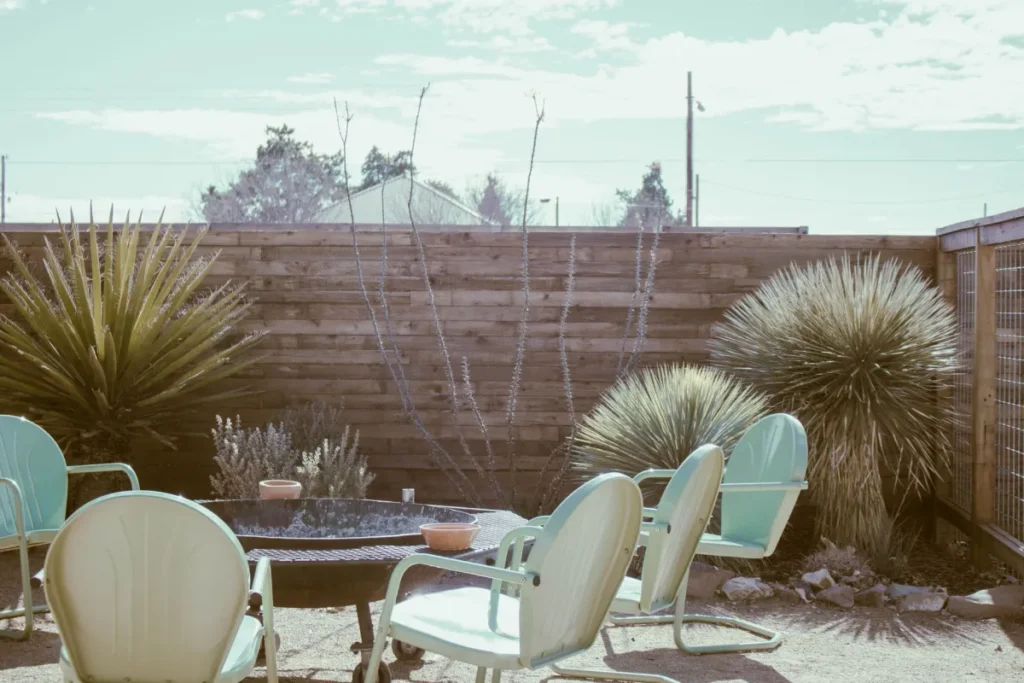 Covered patio outdoor remodeling in Arlington TX with ceiling fan and seating area
