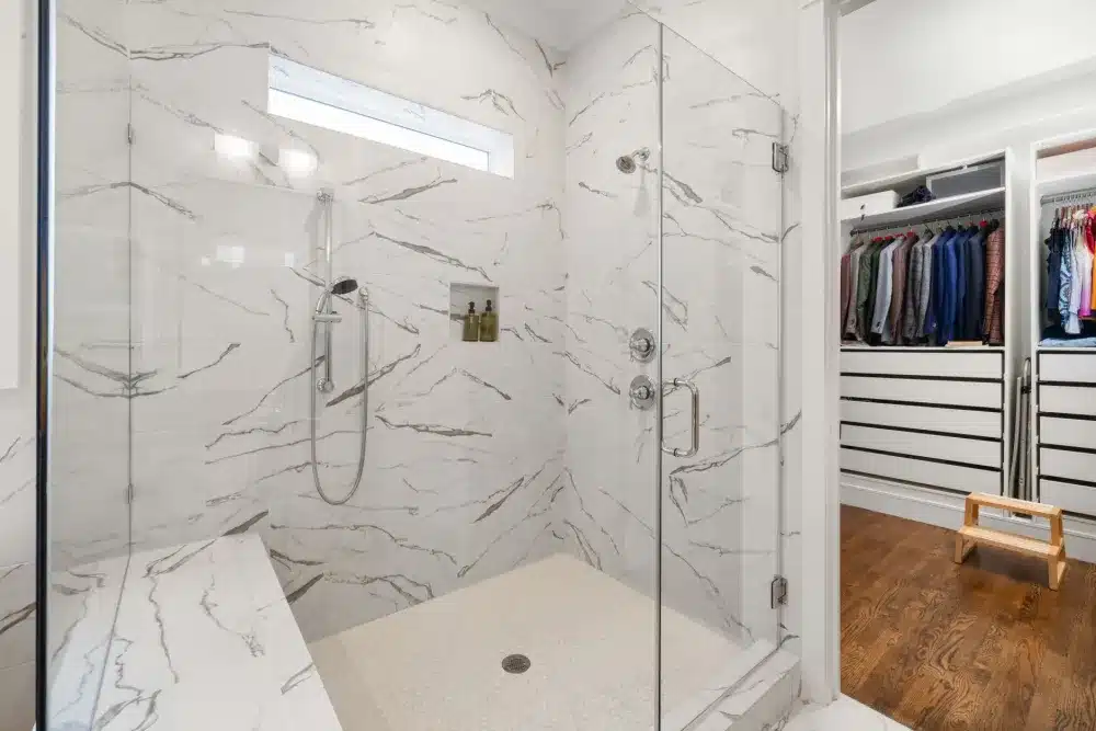 Completed walk-in shower renovation with frameless glass door and modern fixtures