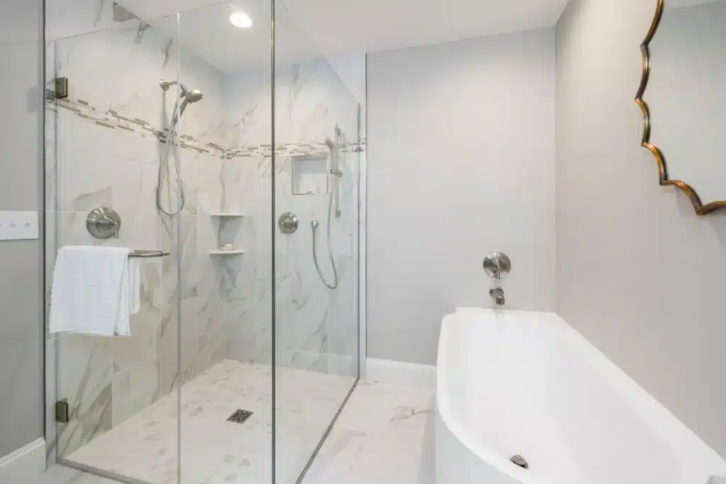 Modern frameless glass shower enclosure in a remodeled Hurst TX bathroom