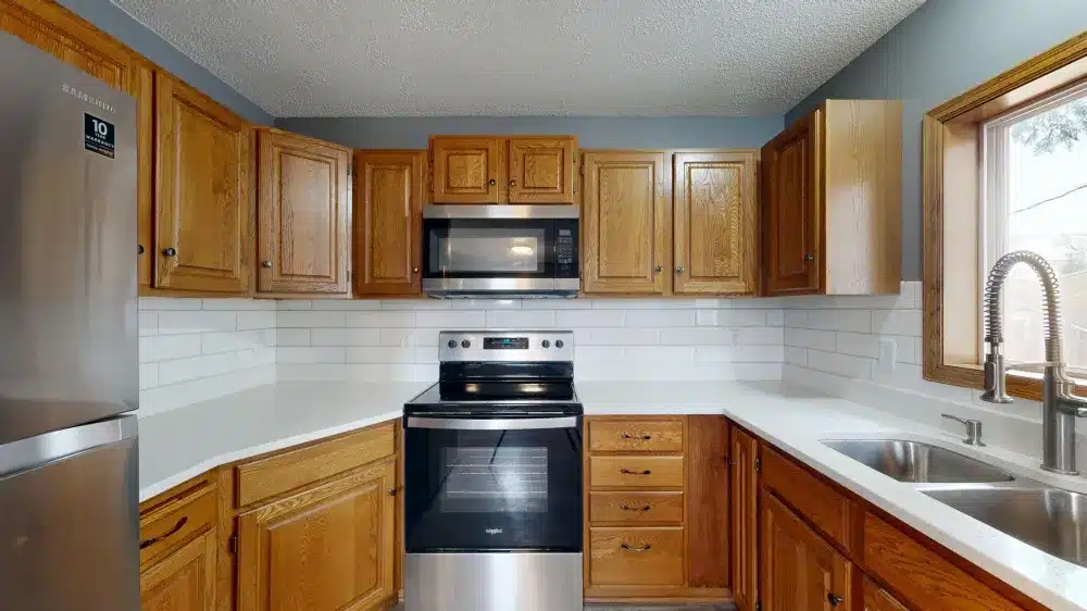 Outdated honey-oak kitchen cabinets showing signs an upgrade is needed in Bedford TX