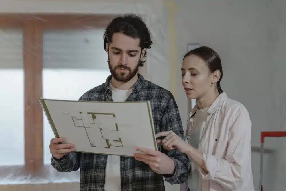 Homeowner and remodeling contractor reviewing kitchen renovation plans in Bedford Texas
