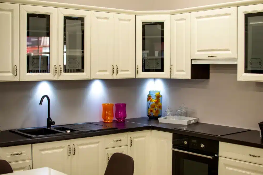 Contractor installing new shaker-style cabinets during a kitchen remodeling project in Hurst TX