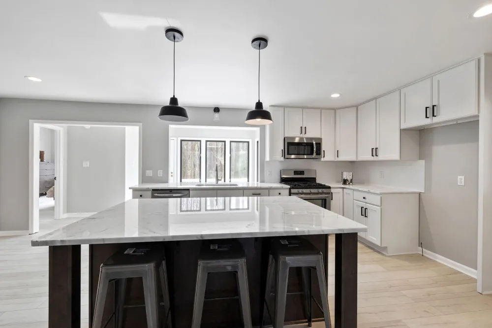 Finished open-concept kitchen renovation with new island and pendant lighting in Hurst TX