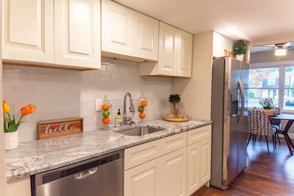 Newly remodeled kitchen with white shaker cabinets and quartz countertops in Hurst TX home