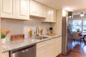 Newly remodeled kitchen with white shaker cabinets and quartz countertops in Hurst TX home