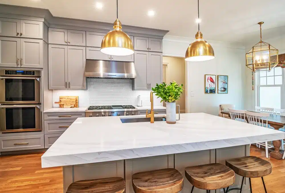 Kitchen island with pendant lighting and waterfall quartz countertop in a DFW remodel