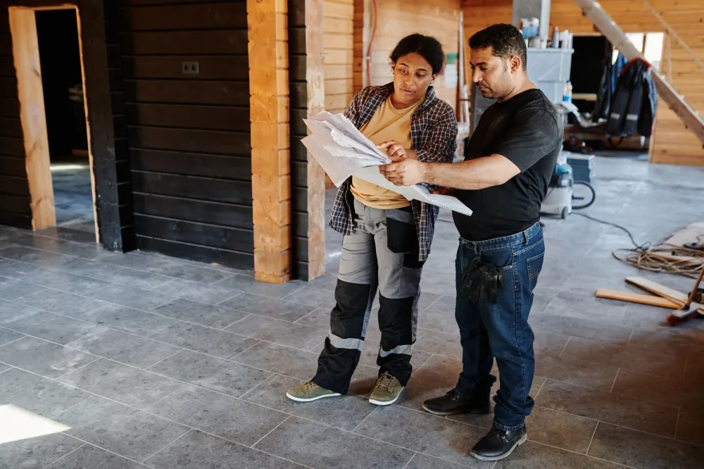 Remodeling contractor reviewing master bathroom renovation plans with Hurst TX homeowner
