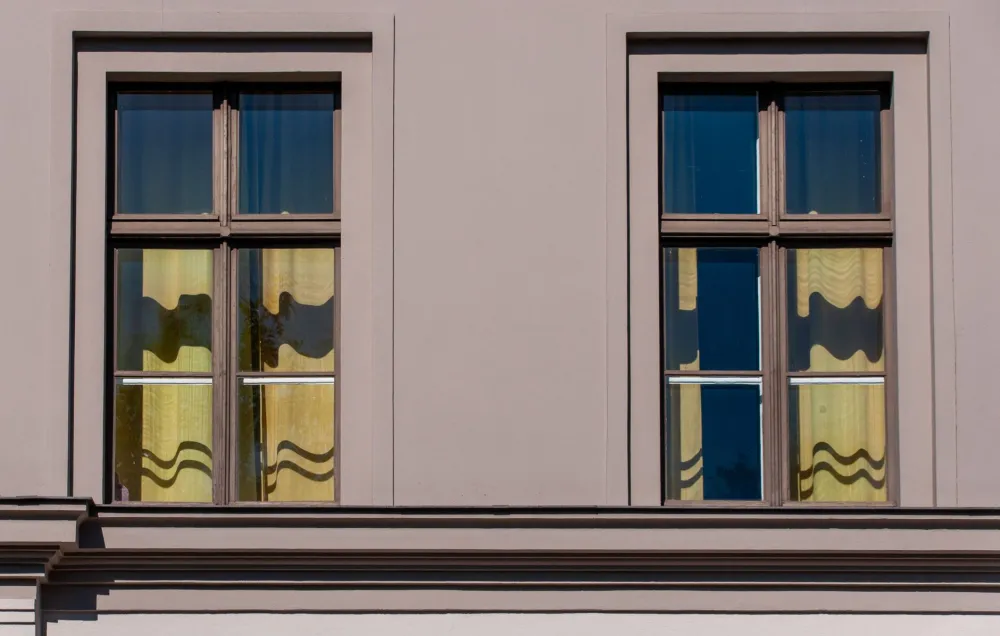 Contractor installing double-pane replacement windows in a Texas residential home