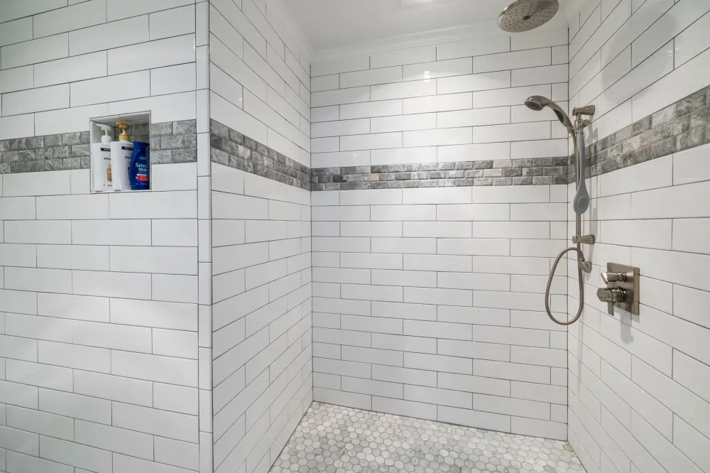 Close-up of fresh subway tile installation inside a remodeled shower in Arlington Texas
