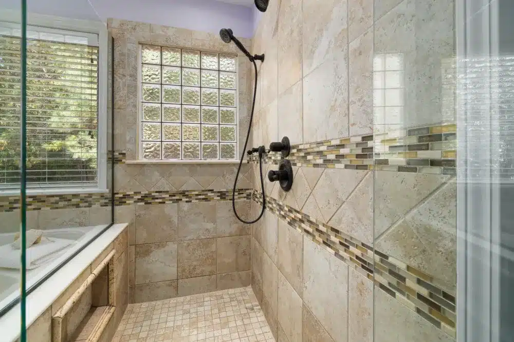 Waterproofing membrane applied to shower walls before tile installation in a bathroom remodel