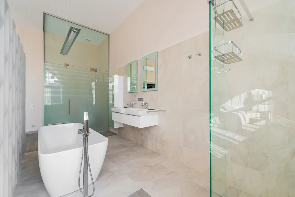 Completed walk-in shower remodel with frameless glass enclosure and large-format porcelain tile