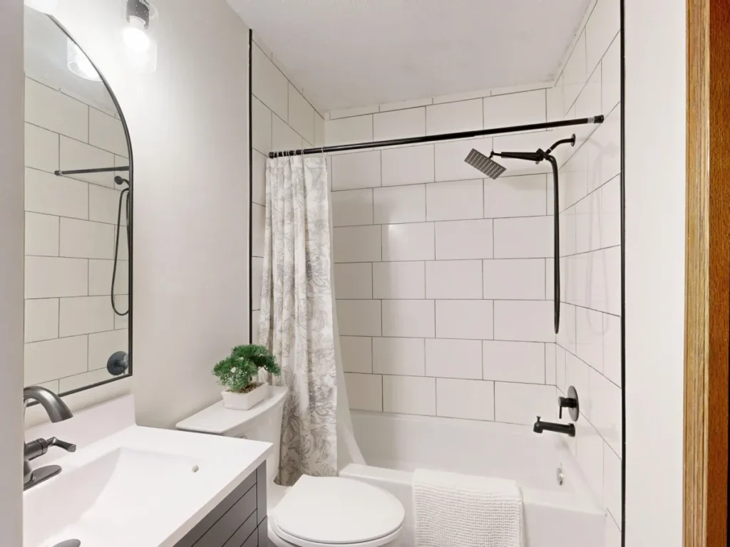Modern shower remodel with large-format tile and frameless glass enclosure in Arlington TX home