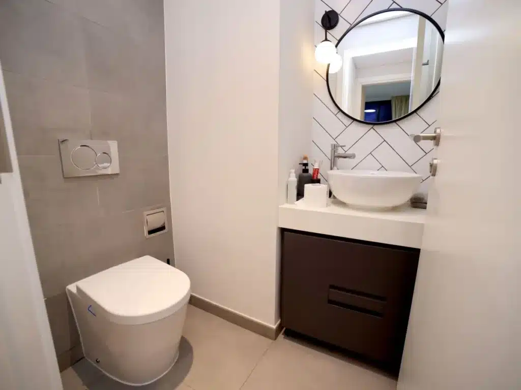 Small bathroom remodel in Bedford TX with modern tile vanity and walk-in shower