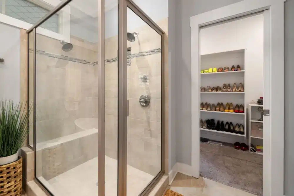 Frameless glass walk-in shower enclosure installed in a small bathroom renovation