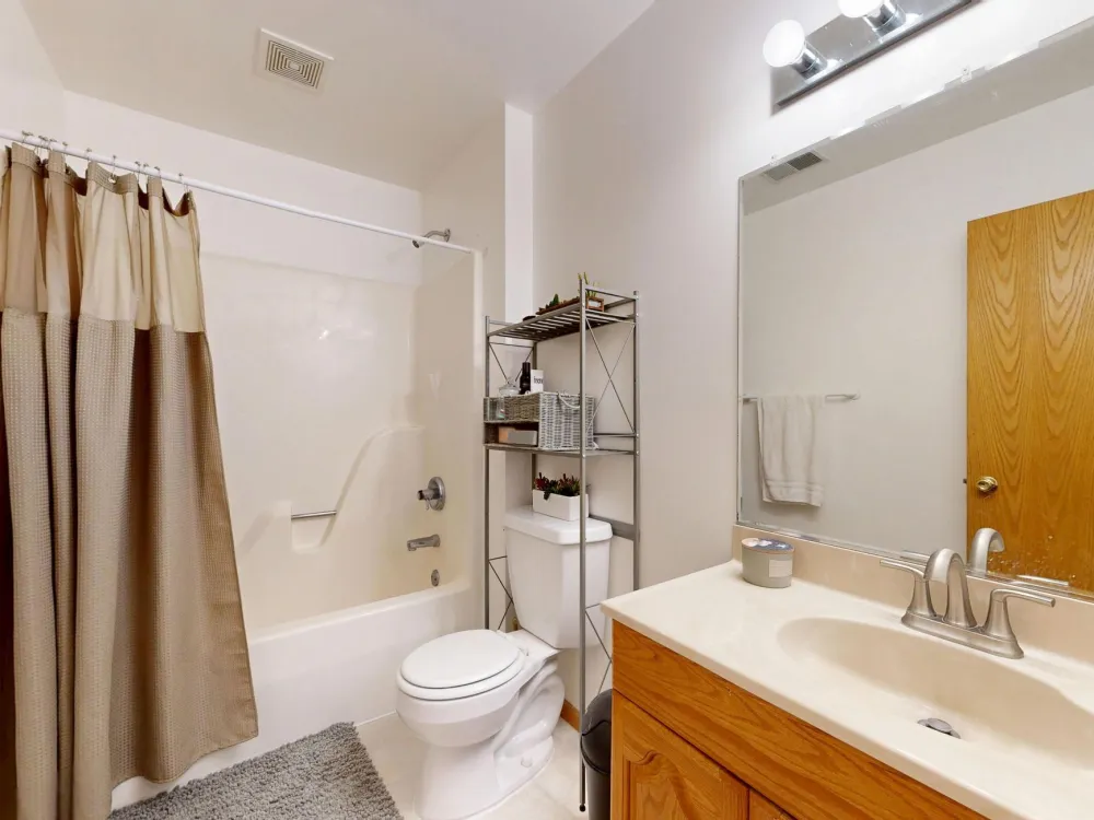 White acrylic shower surround being installed in a DFW bathroom remodel