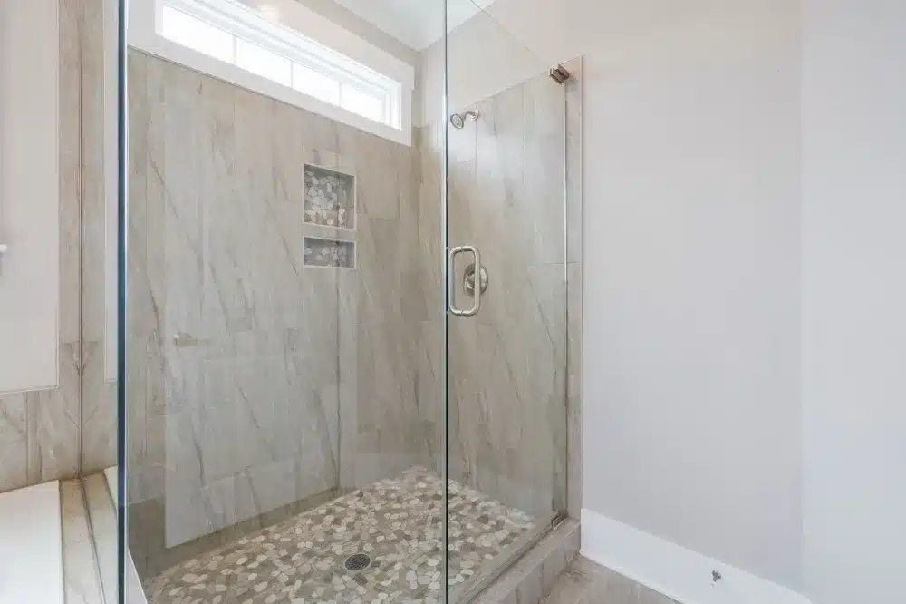 Frameless glass shower enclosure in a remodeled Arlington Texas bathroom