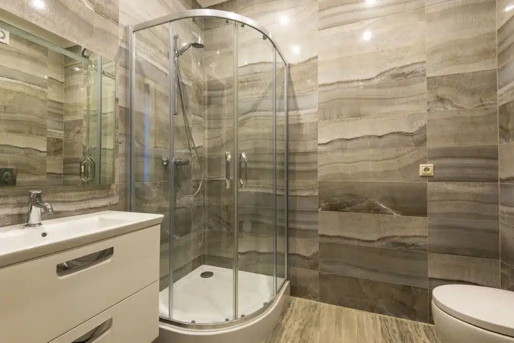 Frameless glass shower enclosure with subway tile in a renovated Hurst Texas bathroom